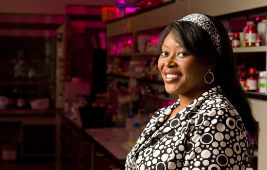 Rabi Musah smiles inside her lab space on campus.