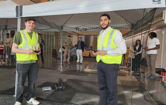CEHC students Jay Parker and Hadley Santos control drones and robotics in the pop up tent at ETEC.