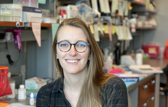 RNA Institute Postdoctoral Fellow Hannah Shorrock is seated in her office at the RNA Institute.