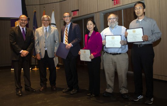 Winners of the President's Excellence Award for Research and Creative Activities pos, holding their certificates, with the President