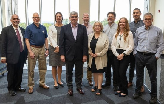 PNNL and DHS leaders stand with CEHC faculty at the ETEC atrium.