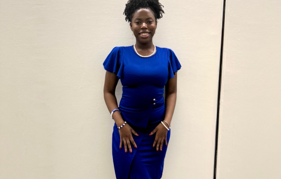 Kayla Rankin poses in a blue dress at her internship in Washington DC.