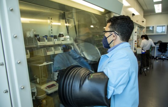UAlbany chemist Jeremy Feldblyum conducts experiments inside a sealer container, called a glovebox, at his ETEC lab.