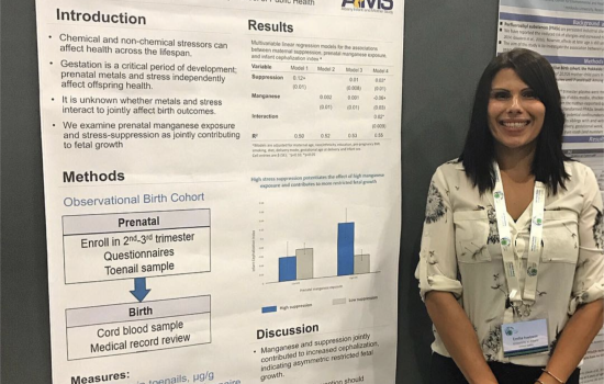 Emilia stands in front of a research poster.