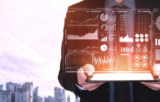 A person holding a tablet with graphs and data.