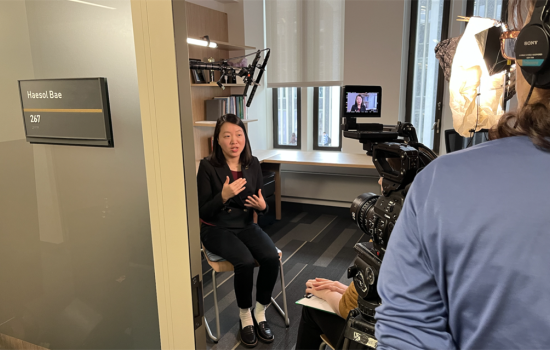 woman sitting in an office talking while being filmed