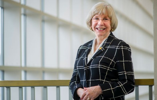 Edelgard Wulfert smiles in a black and white lined blazer.