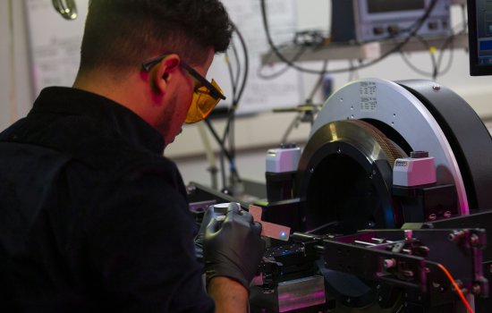 A student at the College of Nanotechnology, Science, and Engineering works on a nanoscale device.