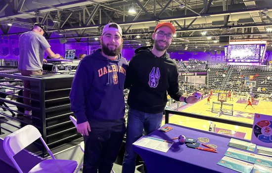 UAlbany Gift of Life Vice President Nick Tassielli and President Benjamin Marzouk stand next to a table with swab kits inside the Broadview Center.