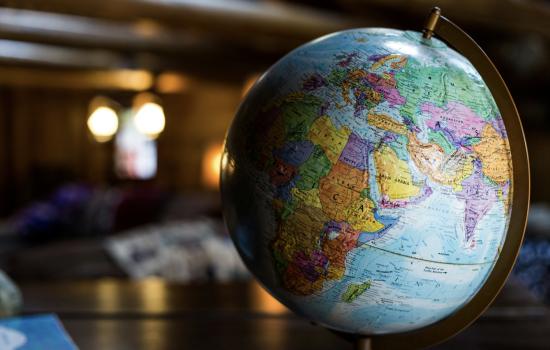 A globe sits on a table with the continents of Africa, Asia and Europe facing the viewer.