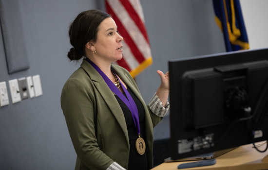 Dr. Jetelina wears the Axelrod Prize medal and stands at the podium to give her lecture.