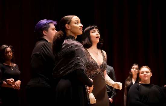 Young people in fancy clothes perform at a vocal recital