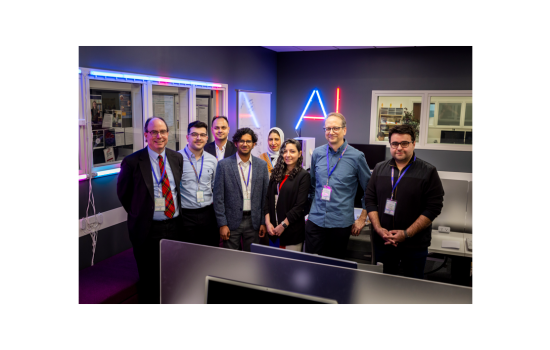 Information Science PhD Students with Keynote Speaker Jonathan Rochelle, Professor Abdullah Canbaz and Malcolm McPherson, member of the FIRST Board in the AI in Complex Systems Lab (Photo by Brian Busher)