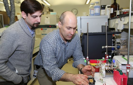UAlbany researchers Ben Taubner and Nate Cady work on a semiconductor device in Dr. Cady's lab at the College of Nanotechnology, Science, and Engineering at the University at Albany.