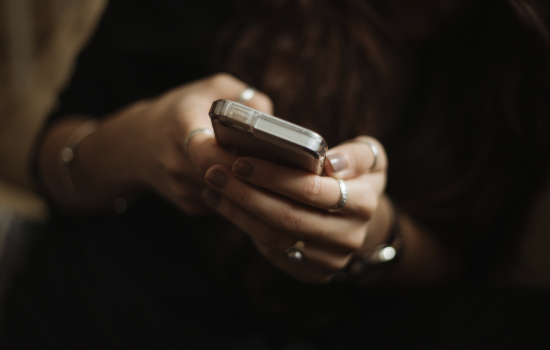 Up-close shot of a woman holding a smartphone in her hands.