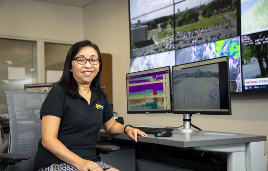 June Wang sits in front of dual monitors inside the NYS Mesonet Operations Center at ETEC.