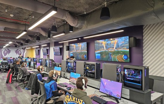 A row of students compete in Rocket League from gaming PCs inside the UAlbany Esports Arena.