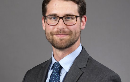 Man in suit and wearing glasses