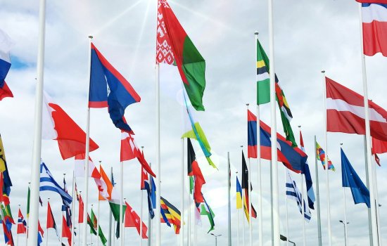 Flags from around the world wave in the wind.