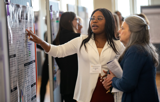 A student presents to a staff member on UAlbany Showcase Day.
