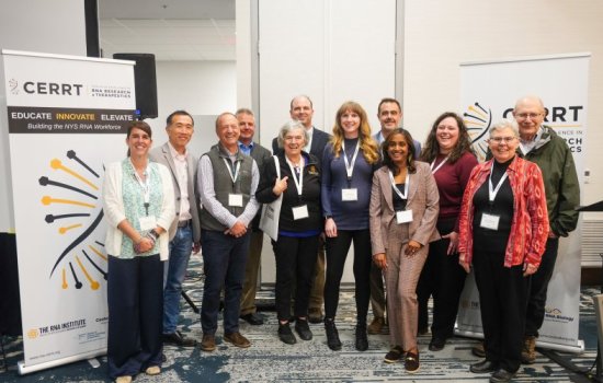 Group pose of smiling researchers at the Symposium.