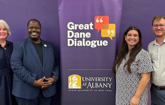 UAlbany community members stand by banner for the Great Dane Dialogue