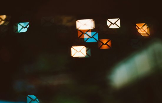 a graphic of small envelopes for e-mail over a digital distorted screen.