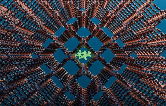 Computer rendering of a metal-organic framework. The image features a lattice of brown rods and blue nodes, arranged in a 3D crosshair pattern. In the center is a shape made of green rods and green nodes in a cluster, trapped in a central square.
