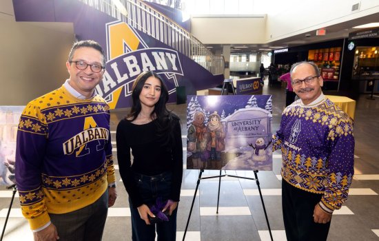 Student stands with President and Vice President with her winning artwork