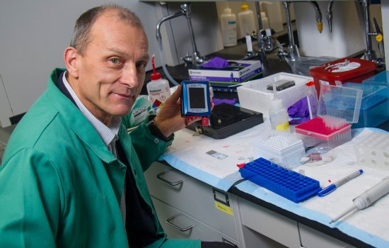 Igor Lednev holds a portable Raman spectrometer.