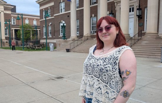 A portrait of Erin Forkin in front of the Downtown Campus.