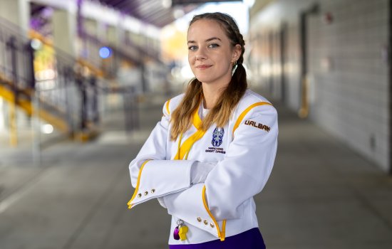Grace Augenstern stands with her arms crossed in the Tom & Mary Casey Stadium concourse.