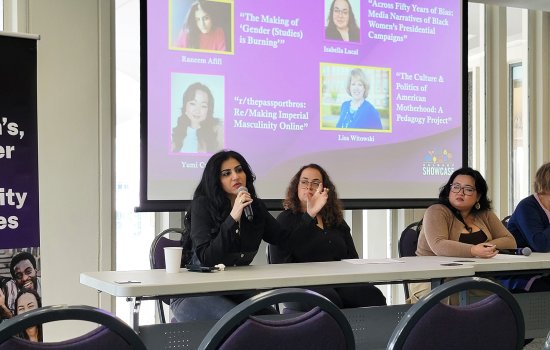 A panel of women are seated indoors speaking about their women's, gender and sexuality studies final projects during Showcase 2026 at UAlbany.