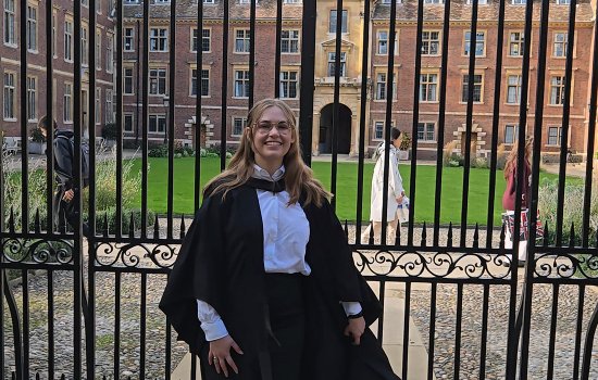 Kate Bucek of UAlbany stands in front of Cambridge University after receiving her graduate degree.