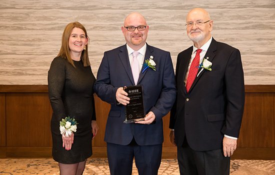 IEEE Vice President for Educational Activities Witold Kinsner and EAB Awards and Recognition Committee Chair Lorena Garcia present Andrew with his award