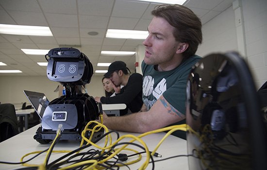 ECE student with robot used in Capstone Design real-world project