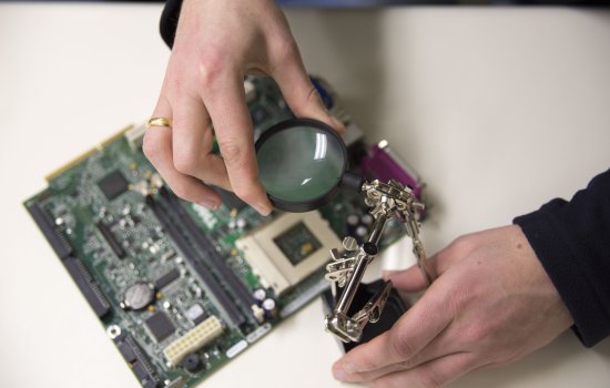 Electrical and Computer Engineering student working with circuit board