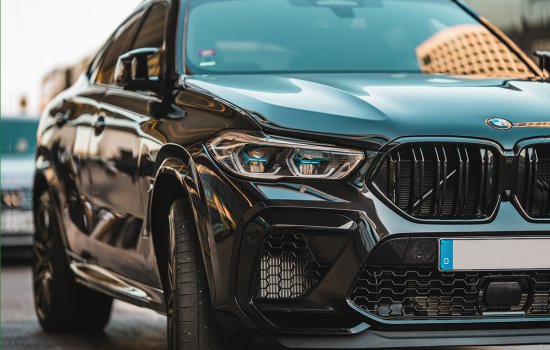 A black Mercedes Benz moving up close at street level