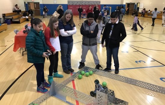 Kids and teacher working on robotics