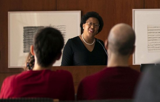 Professor Janell Hobson is framed by heads in the audience as she speaks from a podium