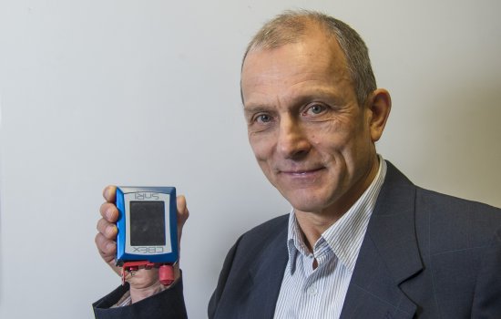 Chemist Igor Lednev displays a portable Raman spectrometer.
