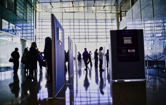 People looking at photos during the 2019 Photovoice event.