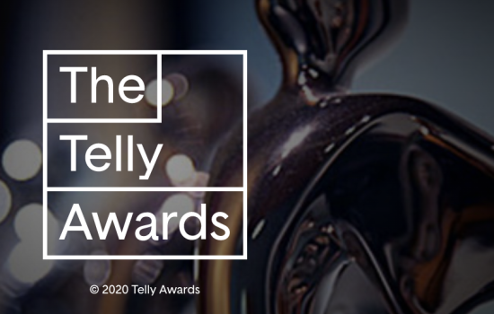 "The Telly Awards" is written in white on top of a dark background image of a dim gold trophy.
