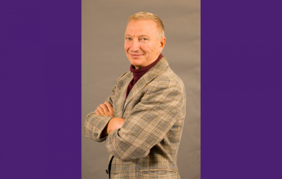 Photo of a man smiling at the camera.