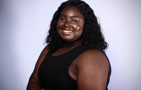 Eliane Alexandre, in a black tank top, smiles 
