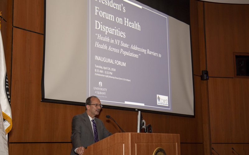 President Rodríguez speaking at the podium at the inaugural President's Forum on Health Disparities, in 2018.