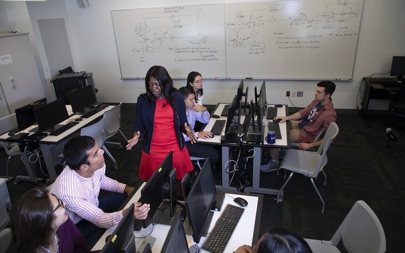 Victoria Kisekka, an assistant professor of information security and digital forensics, trains students in a cyber lab at the School of Business. (Photo by Patrick Dodson)