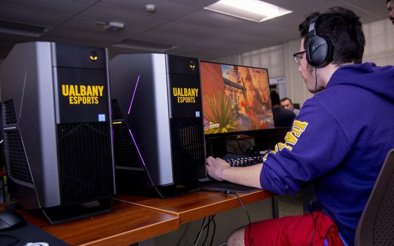 Photo of a UAlbany eSports student in the competitive gaming arena at Draper Hall.