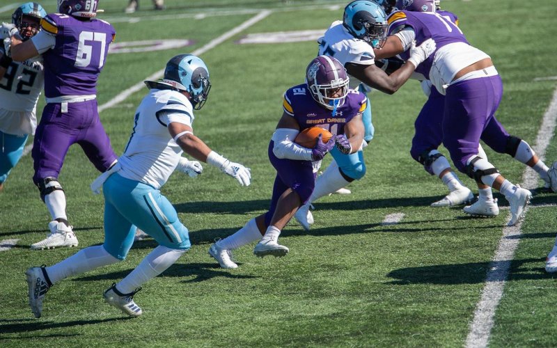 UAlbany running back Karl Mofor races through defenders on the football field