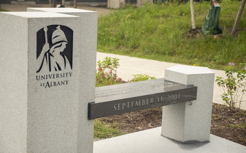 Image of UAlbany's 9/11 memorial bench on the walking path to ETEC.